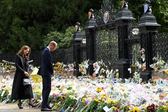 The Prince and Princess of Wales view floral tributes left by members of the public at the gates of Sandringham House in Norfolk, following the death of Queen Elizabeth II. Picture date: Thursday September 15, 2022. PA Photo. See PA story DEATH Queen. Photo credit should read: Toby Melville/PA Wire
