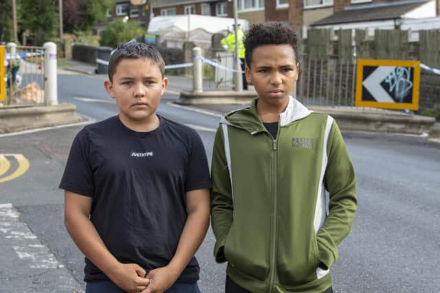Alfie Wilkinson and  Rueben Duncan-Keane who laid at the scene where a 15 year old boy was stabbed and died of his injuries outside North Huddersfield Trust School on Woodhouse Hill , Fartown in Huddersfield . Picture Tony Johnson