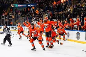 Magic moment: Sheffield Steelers players pour off the bench after completing the Elite League trophy treble (Picture: Dean Woolley)