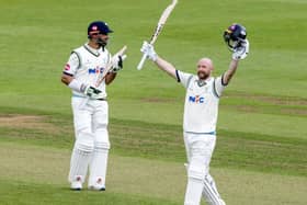 Adam Lyth celebrates his third century of the season at Wantage Road as captain Shan Masood applauds in the background. Picture: John Heald.