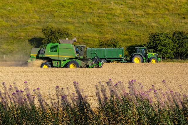 Farmers harvesting wheat in fields. PIC: Tony Johnson