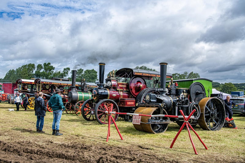 Visitors look at the traction engines in the weather-damaged show field