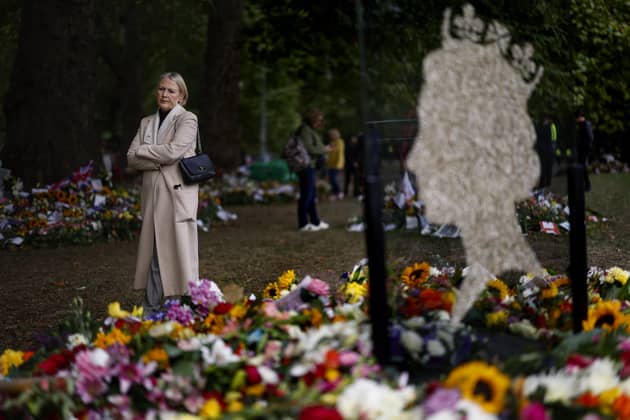 People view flowers at a memorial site in Green Park near Buckingham Palace following the death of Queen Elizabeth II