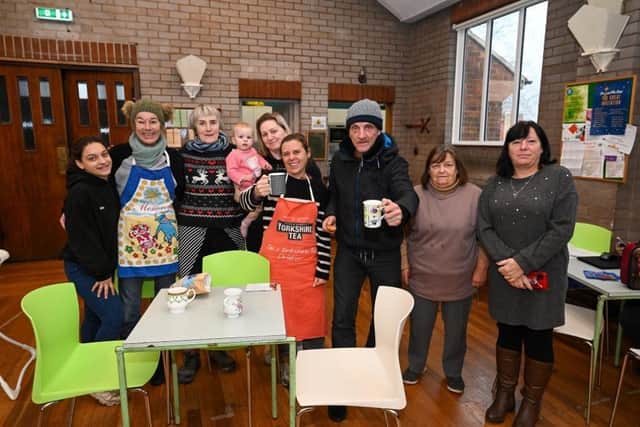 Volunteers and visitors at St Philip's The Hot Pot warm space, including manager Wendy Gillings (fourth from right) and visitor Tony Dearing (third from right). (Image: Duncan Young)