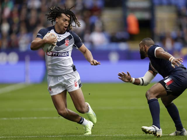 BRIGHT FUTURE: England's Dom Young (left) hands off France's Samisoni Langi during the Rugby League World Cup Group A match at the University of Bolton Stadium on Saturday. Picture: Richard Sellers/PA.