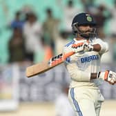 Century-maker Ravindra Jadeja embarks on his trademark sword celebration, albeit more subdued this time, moments after running out debutant Sarfaraz Khan in the Rajkot Test. Photo by Gareth Copley/Getty Images.