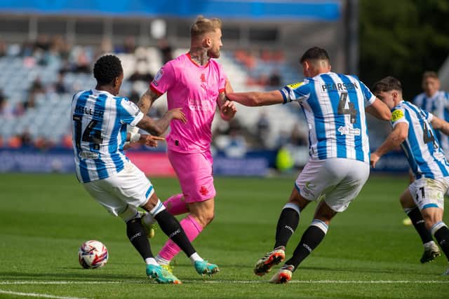 Huddersfield Town defender Matty Pearson (centre right) challenges Barnsley rival Stephen Humphrys in the recent League One game at the John Smith's Stadium. Picture: Bruce Rollinson.