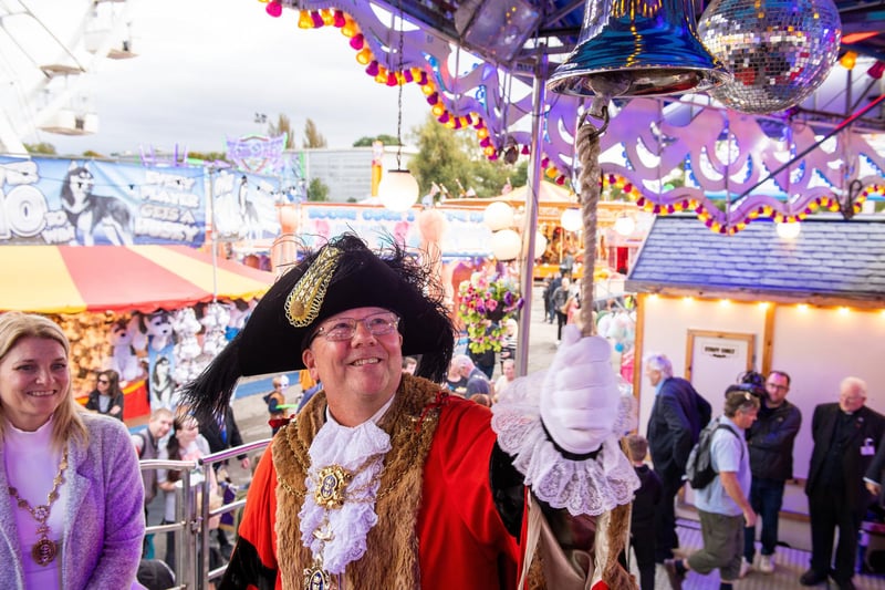 The Lord Mayor, Councillor Kalvin Neal rings the bell on the Sea Storm ride to  declare the Hull Fair open.