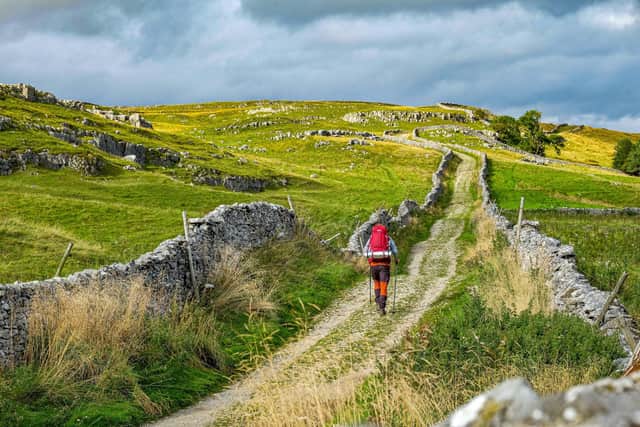 A hiker makes his way towards Pen-Y-Ghent along the bridleway above Horton in Ribblesdale in the Yorkshire Dales National Park. Organisations have signed a letter to the Prime Minister, calling on the government to accept amendments in the Levelling Up Bill for greater nature protection in National Parks and Areas of Outstanding Natural Beauty in England.