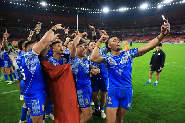 Stephen Crichton of Samoa takes a selfie with team-mates following the victory over England. (Photo by Matthew Lewis/Getty Images for RLWC)