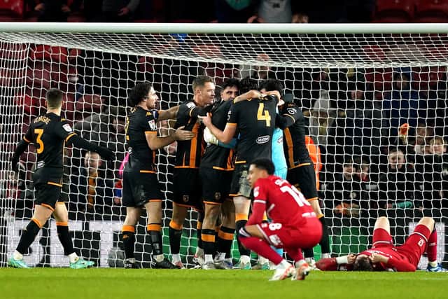 PARTY TIME: Hull City players rejoice at full-time as Middlesbrough's are left dejected