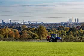 A farmer crop spraying near Skidby Mill on land overlooking Kingston Upon Hull. Police have been working with local farmers to mark property as tractors in the area are being targeted for GPS thefts to fuel a growing global market.