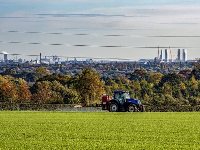 A farmer crop spraying near Skidby Mill on land overlooking Kingston Upon Hull. Police have been working with local farmers to mark property as tractors in the area are being targeted for GPS thefts to fuel a growing global market.