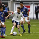 Huddersfield Town's Japan midfielder Yuta Nakayama, left, challenges Leeds United's USA midfielder Aaronson Brenden (second right) during the friendly football match between Japan and United States in Dusseldorf, western Germany, on September 23, 2022. (Photo by NORBERT SCHMIDT/AFP via Getty Images)