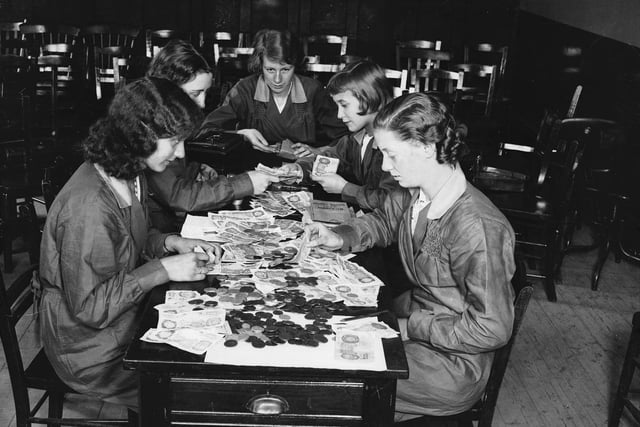 Students at a Sheffield commercial college learn to count money in September 1936.