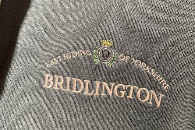 Clothing shop in China selling attire with British town names on clothing including Bridlington and Sheffield