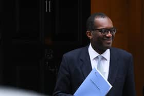 Britain's Chancellor of the Exchequer Kwasi Kwarteng holds a folder reading "The Growth Plan 2022" as he walks out of Number 11 Downing Street on his way to unveil an anti-inflation budget plan in London on September 23, 2022. - The UK's new government will unveil multi-billion-pound measures aimed at supporting households and businesses hit by the highest inflation in decades. (Photo by Daniel LEAL / AFP) (Photo by DANIEL LEAL/AFP via Getty Images):Kwasi Kwarteng