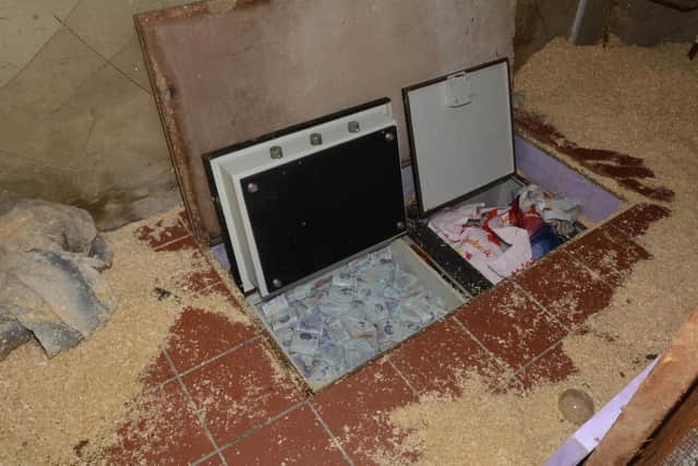 Two secret safes were discovered side by side underneath the sawdust-strewn tiled floor of an outbuilding where a dog was kept.