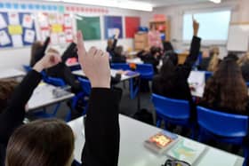 Pupils raise their hands in a lesson. (Pic credit: Anthony Devlin / Getty Images)