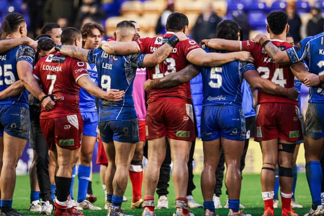 Samoa and Tonga players join in a huddle after a game at the Rugby League World Cup. PIC: Alex Whitehead/SWpix.com
