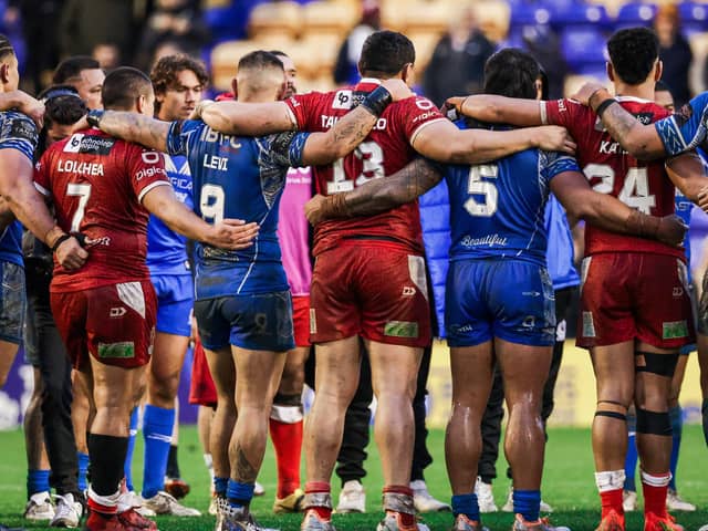 Samoa and Tonga players join in a huddle after a game at the Rugby League World Cup. PIC: Alex Whitehead/SWpix.com