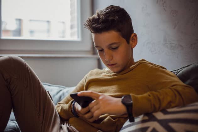 A generic photo of a teenage boy on his mobile phone. PIC: iStock/PA