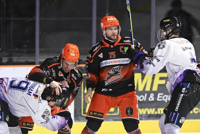FIGHTING TALK: Sheffield Steelers' Zach Vinnell (left) and captain Robert Dowd get to grips with a couple of Manchester opponents. Picture: Dean Woolley/Steelers Media.