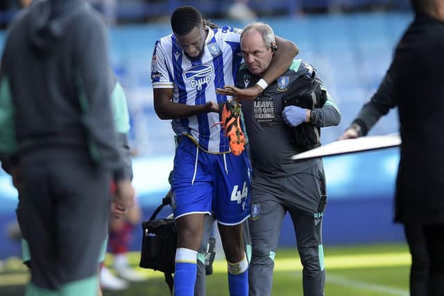 INJURED: Momo Diaby hobbles off as his Sheffield Wednesday debut is cut short