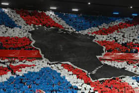 Rangers fans make a mural of the Union Jack to pay tribute to Her Majesty Queen Elizabeth II, who died away at Balmoral Castle on September 8 prior to the UEFA Champions League group A match between Rangers FC and SSC Napoli at Ibrox Stadium on September 14, 2022 in Glasgow, Scotland. Picture: Stu Forster/Getty Images.