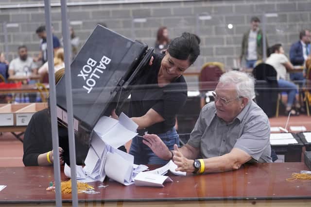 Votes are emptied from ballot boxes onto the tables. PIC: Danny Lawson/PA Wire