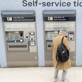 A person uses a ticket machine at Waterloo train station in London. PIC: PA