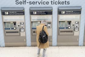 A person uses a ticket machine at Waterloo train station in London. PIC: PA