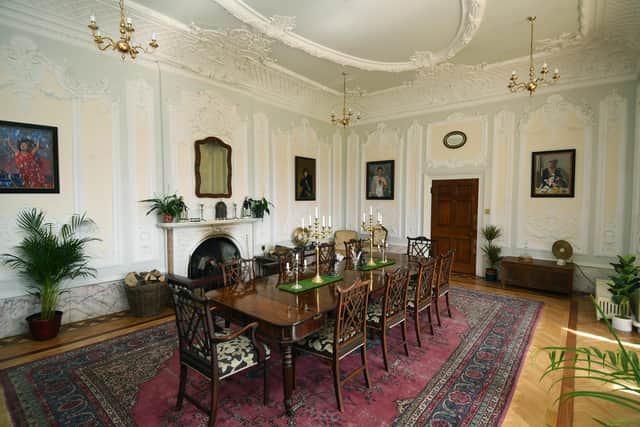 The formal dining room with period and contemporary paintings including some by Andre Durand