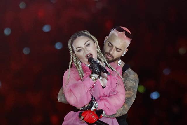 Colombian singer Maluma (back) performs on stage along with pop icon Madonna during his concert "Medallo in the Map", in Medellin, Colombia, on April 30, 2022. (Photo by Fredy BUILES / AFP) (Photo by FREDY BUILES/AFP via Getty Images)