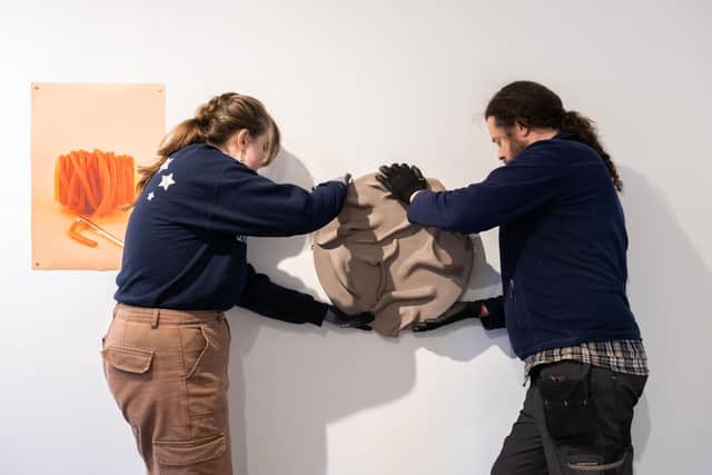Artwork being installed from the Different by Design Exhibition.