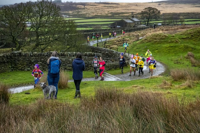 31 December 2022.....      Runners set off onto the moors at the start of the Auld Lang Syne fell race at Haworth for the annual New Years Eve event.  Picture Tony Johnson