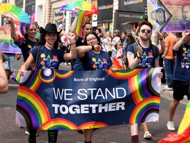 Staff from the Bank of England joined the parade carrying a "We Stand Together" banner