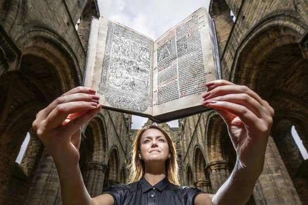 Senior librarian Rhian Isaac holds a rare copy of Missale ad usum Cistercienci, also known as the Kirkstall Missal, which has been returned to the ruins of Kirkstall Abbey, Leeds, where it was diligently inscribed and studied by monks more than 500 years ago