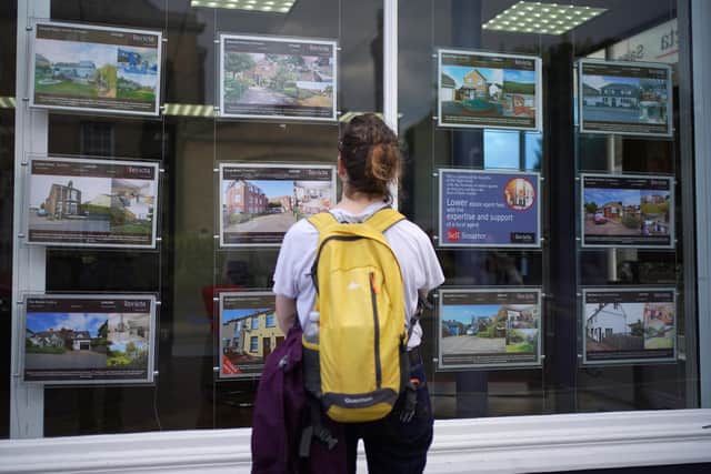 A woman looking at advertisements in an estate agents window. Picture: Yui Mok/PA Wire