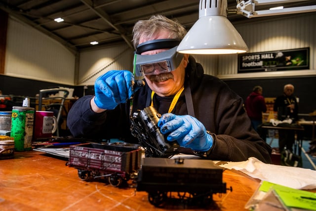 Barry Oliver, of Leeds, demonstrates the art of 'Weathering' which means making new items look old as he prepares these OO gauge tank wagons.