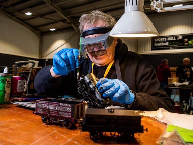 Barry Oliver, of Leeds, demonstrates the art of 'Weathering' which means making new items look old as he prepares these OO gauge tank wagons.