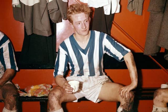 LEGENDARY FIGURE: Huddersfield Town striker Denis Law enjoys a cup of tea in the dressing room after a game in 1957