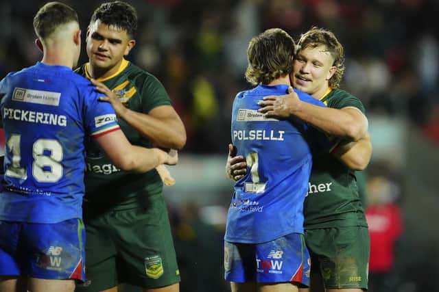 Australia's Reuben Cotter, far right, embraces with Italy's Luke Polselli at the end of the game at the Totally Wicked Stadium. (AP Photo/Jon Super)
