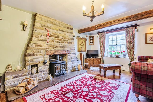 The sitting room with views and a cosy wood-burning stove