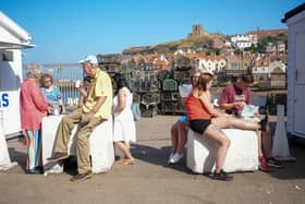 People eat fish and chips and take away food on a busy day in Whitby. (Pic credit: Christopher Furlong / Getty Images)