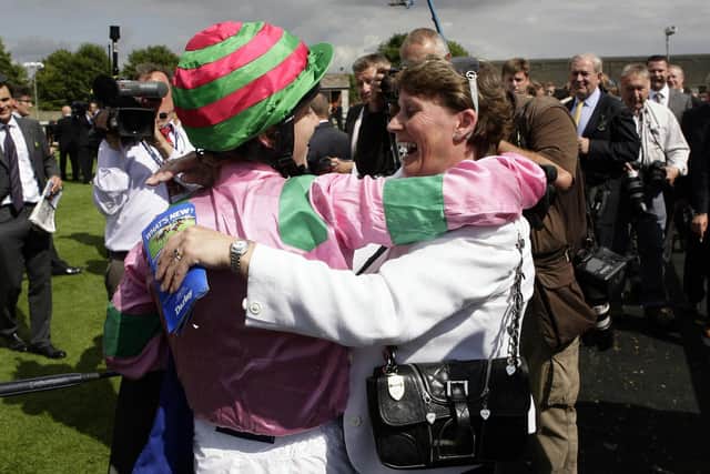 Trailblazer: Jockey Hayley Turner celebrates with Alex Greaves, right, after winning the Darley July Cup on Dream Ahead in July 2011.