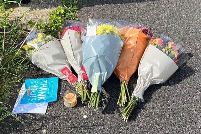Flowers left at the scene on Harpe Inge, Huddersfield, near a property where paramedics found a man and woman with multiple injuries on Monday. A man in his 30s has been arrested by West Yorkshire Police on suspicion of murder.  Katie Dickinson/PA Wire