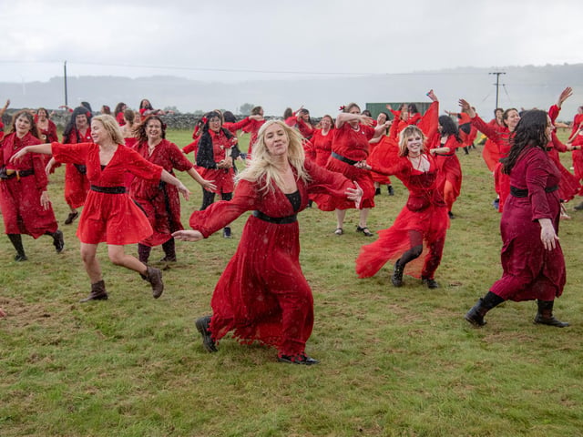 Participants gather at Penistone Country Park in Haworth for Actually the Most Wuthering Heights Day Ever - a celebration of all things Wuthering Heights, Kate Bush and Emily Brontë in the stunning setting of the Haworth moors.  500 people took part in the mass 'Wuther' in a joyful, windswept, red-dress sea of Cathys dancing for charity, supporting  Women’s Aid Picture by Tony Johnson.  24th July 2026