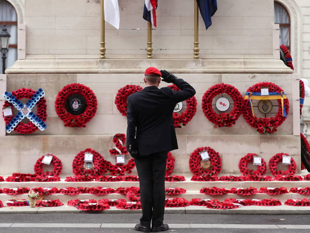 A member of the armed services gives a salute at the Cenotaph on Whitehall in London as the nation falls silent to remember the war dead on Armistice Day. PIC: Yui Mok/PA Wire