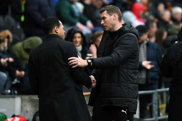 CONTRASTING EMOTIONS: Hull City coach Liam Rosenior shakes hands with Rotherham United manager Matt Taylor